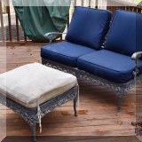 L08. Cast metal outdoor loveseat and ottoman. 